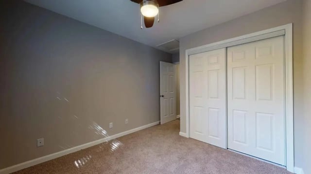 Closet doors ceiling fan and open doorway bedroom at 3116 Hillsborough in Raleigh Student Accommodation