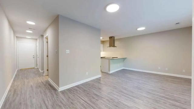 Hallway with white door kitchen island living area Living Area at 3116 Hillsborough in Raleigh Student Accommodation