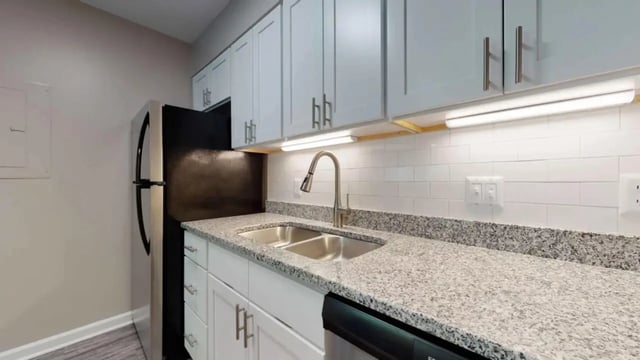 Stainless steel refrigerator, granite countertop, double sink, white cabinets kitchen at 3116 Hillsborough in Raleigh Student Accommodation