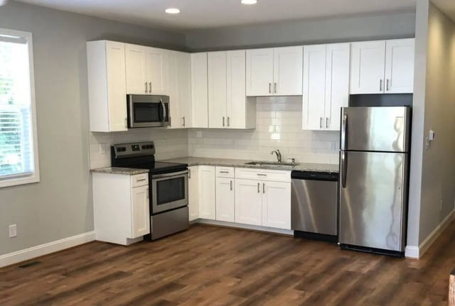 Modern kitchen with white cabinets stainless steel appliances kitchen at The Lookout in Chapel Hill Student Accommodation