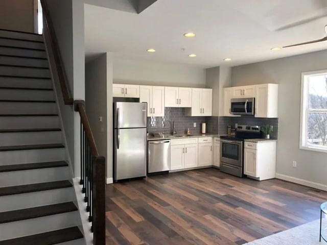 Stairs leading to modern kitchen with stainless steel appliances kitchen at The Lookout in Chapel Hill Student Accommodation