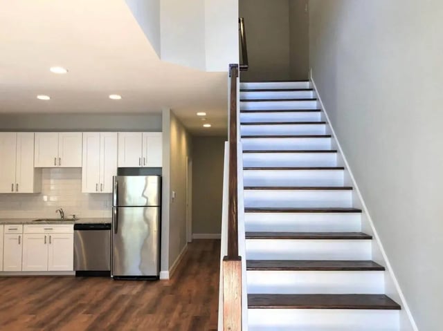 White cabinets stainless steel refrigerator stairs interior at The Lookout in Chapel Hill Student Accommodation