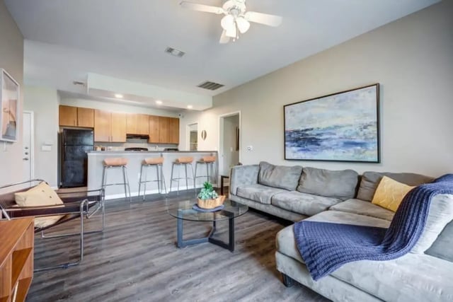 Sofa coffee table kitchen island barstools living room at Madera in San Antonio Student Accommodation