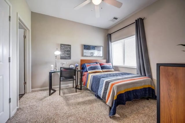 Bed desk chair and window bedroom at Madera in San Antonio Student Accommodation