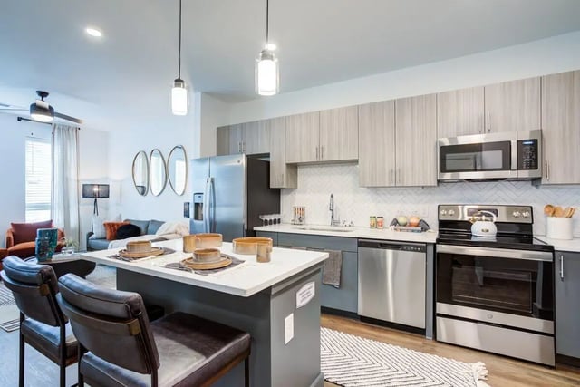 Island with seating and kitchen area at Signature Music Row in Nashville Student Accommodation
