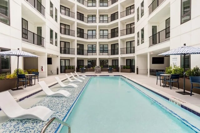 White lounge chairs pool and balconies exterior at Signature Music Row in Nashville Student Accommodation