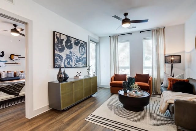 Living room with orange chairs and guitars Image Type Living Room at Signature Music Row in Nashville Student Accommodation