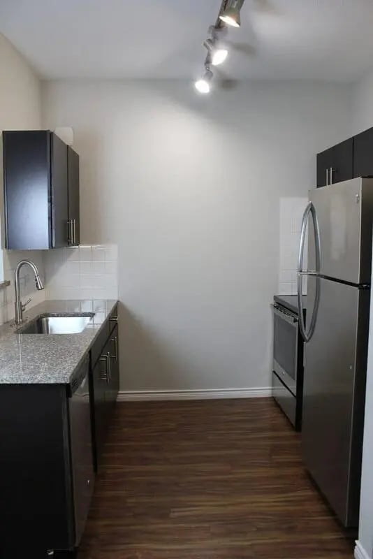 Stainless steel refrigerator sink cabinets oven kitchen at 21 Pearl in Austin Student Accommodation
