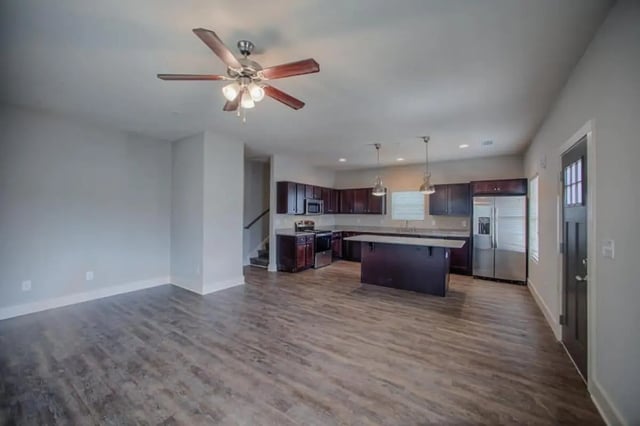 Spacious living area with modern kitchen and island Kitchen Living Room at The Collective at Kennesaw in Kennesaw Student Accommodation