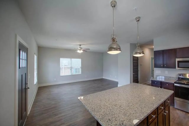 Granite island with pendants and kitchen living room at The Collective at Kennesaw in Kennesaw Student Accommodation
