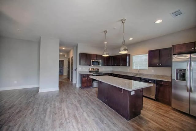 Modern kitchen island cabinets stainless steel appliances kitchen at The Collective at Kennesaw in Kennesaw Student Accommodation