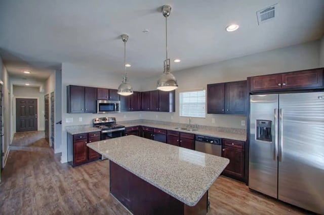 Modern kitchen with granite island and stainless steel appliances kitchen at The Collective at Kennesaw in Kennesaw Student Accommodation