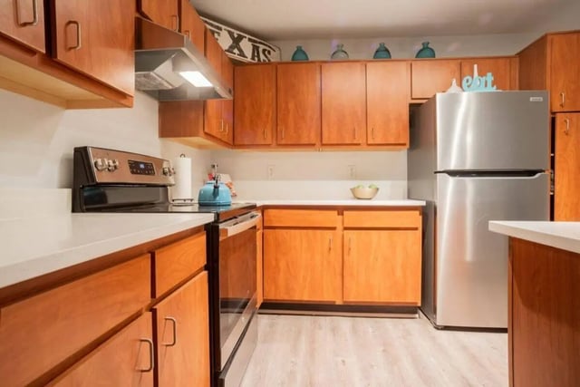 Wooden cabinets stainless steel fridge modern appliances kitchen at Sparq On Rio in Austin Student Accommodation