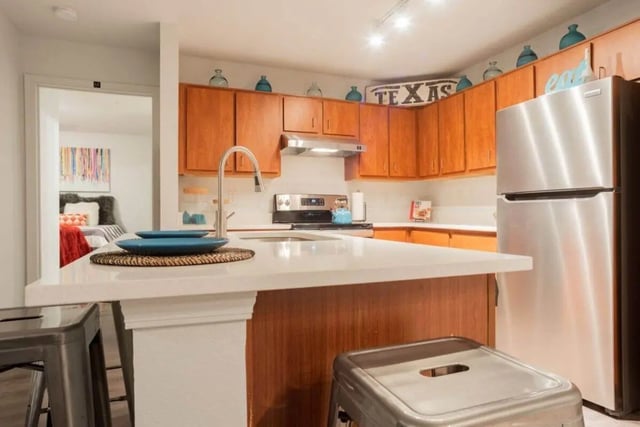 Counter sink faucet refrigerator wooden cabinets kitchen at Sparq On Rio in Austin Student Accommodation