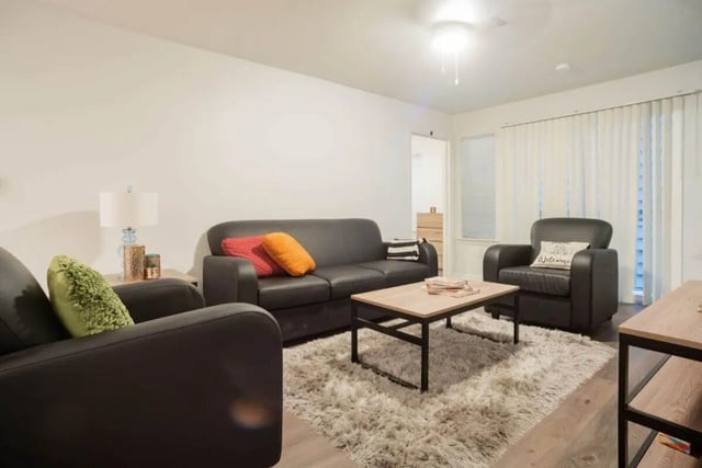 Black couches table rug pillows and lamp living room at Sparq On Rio in Austin Student Accommodation