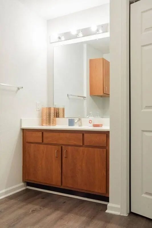 Wood vanity sink mirror and storage bathroom at Sparq On Rio in Austin Student Accommodation