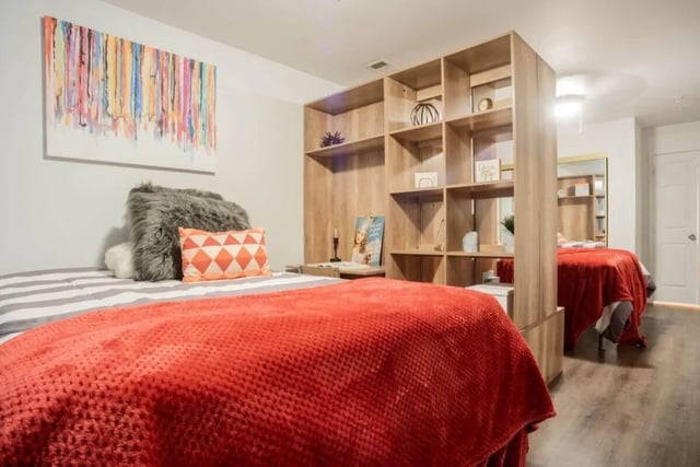 Beds with red throws and shelves bedroom at Sparq On Rio in Austin Student Accommodation