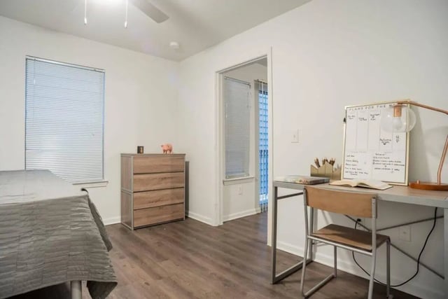 Bed dresser desk and whiteboard bedroom at Sparq On Rio in Austin Student Accommodation