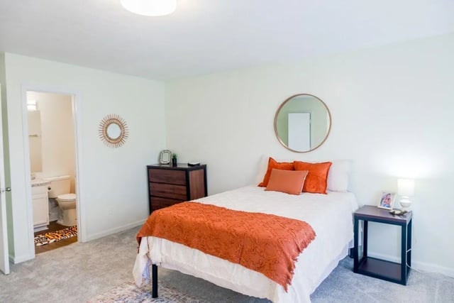 Bed dresser mirror bathroom bedroom bedroom at Logan Square in Auburn Student Accommodation