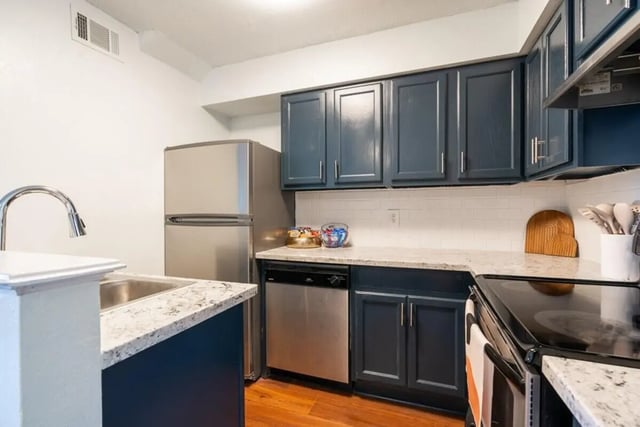 Refrigerator cabinets dishwasher sink countertops kitchen at Logan Square in Auburn Student Accommodation