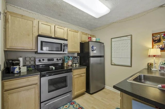 Cabinets microwave oven stove refrigerator kitchen sink kitchen at Logan Square in Auburn Student Accommodation
