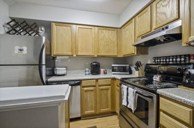 Stainless steel refrigerator microwave dishes and stove kitchen at Logan Square in Auburn Student Accommodation