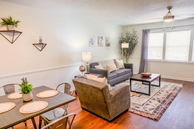 Dining table sofa chairs rug living room at Logan Square in Auburn Student Accommodation