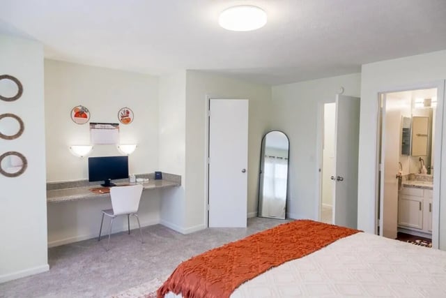 Desk computer mirror and bed bedroom at Logan Square in Auburn Student Accommodation