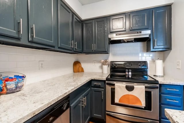 Dark cabinets granite counters stove and snacks kitchen at Logan Square in Auburn Student Accommodation