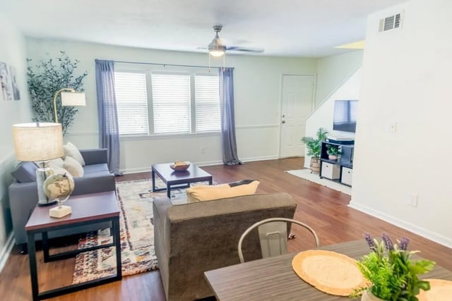Modern living room with couch coffee table and TV living room at Logan Square in Auburn Student Accommodation
