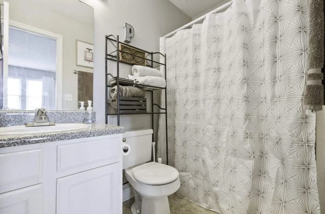 Toilet towels shelving shower curtain bathroom at Logan Square in Auburn Student Accommodation