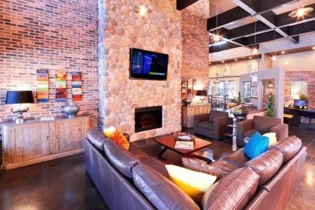 Large sectional sofa fireplace and television living room at Block 43 in Greensboro Student Accommodation