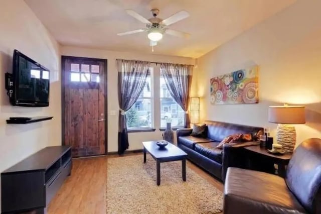 Leather couches TV coffee table living room at Block 43 in Greensboro Student Accommodation