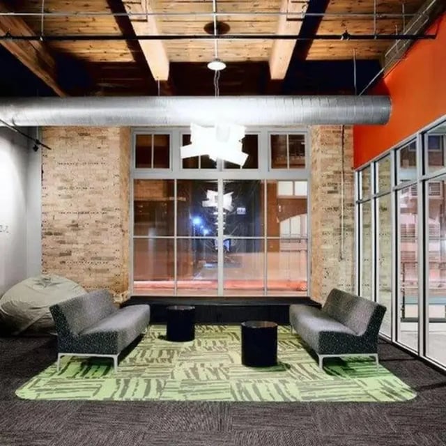 Sofa tables beanbag large window living room at The Letterman Chicago in Chicago Student Accommodation