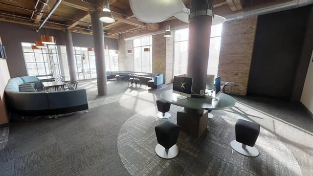 Computers on round table with stools living room at The Letterman Chicago in Chicago Student Accommodation