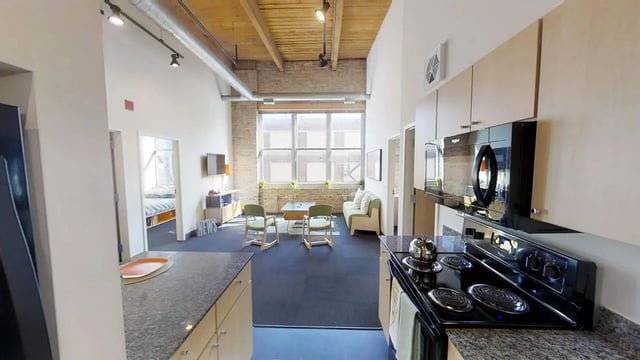 Kitchen stove island living room bedroom dining area. at The Letterman Chicago in Chicago Student Accommodation