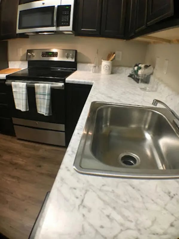 Stainless steel sink with stove and cabinets kitchen at Seahawk Cove in Wilmington Student Accommodation
