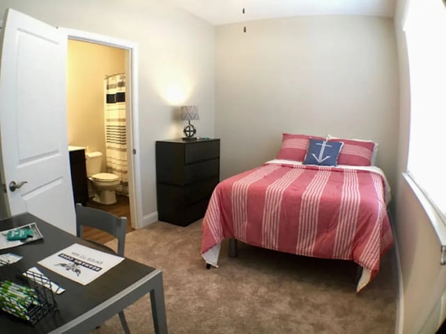 Bed desk and bathroom in student accommodation bedroom at Seahawk Cove in Wilmington Student Accommodation
