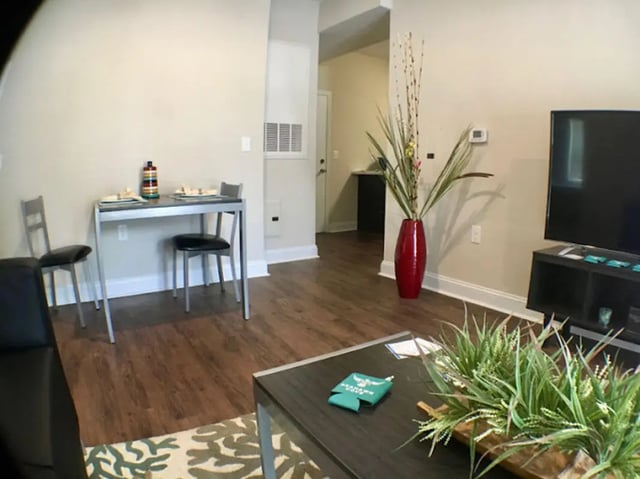Dining table with chairs TV and sofa living room at Seahawk Cove in Wilmington Student Accommodation