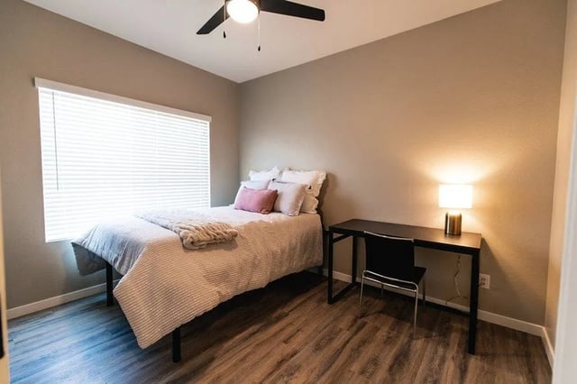 Bed with pillows desk with lamp bedroom at Lofts on 8th in Tempe Student Accommodation