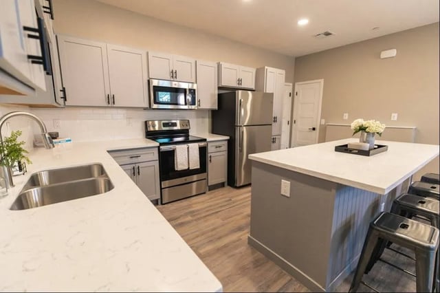 Modern kitchen with island and stainless steel appliances kitchen at Lofts on 8th in Tempe Student Accommodation