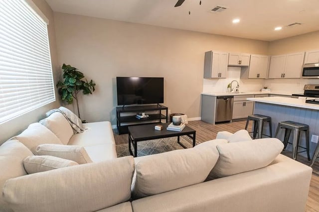 White sofa television and modern kitchen living room at Lofts on 8th in Tempe Student Accommodation