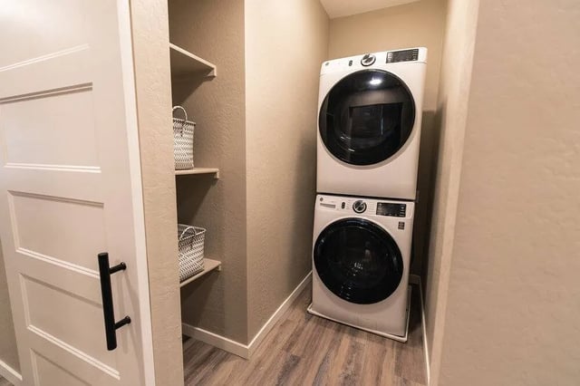 Stacking washer and dryer with shelves laundry room at Lofts on 8th in Tempe Student Accommodation