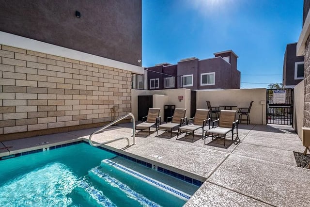 Pool lounge chairs and tables poolside playing area at Lofts on 8th in Tempe Student Accommodation