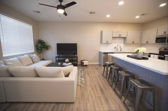 White sectional couch TV kitchen island living room at Lofts on 8th in Tempe Student Accommodation