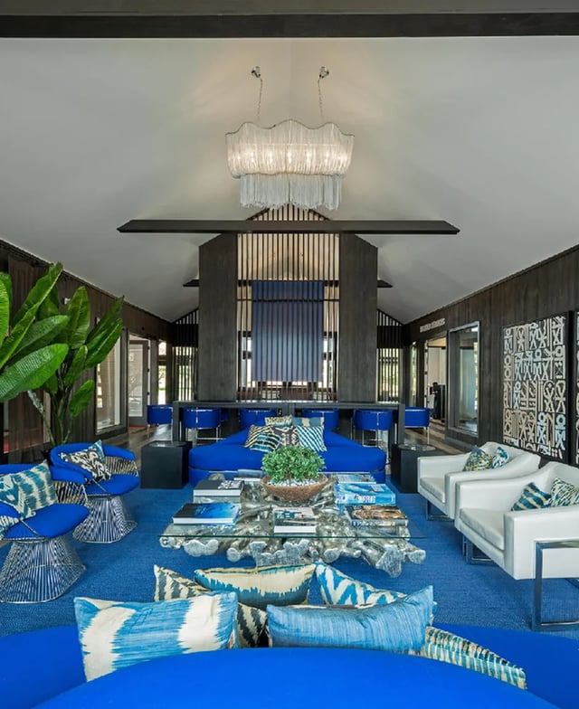 Blue sofas white chairs modern coffee table living room at The Madison in Ames Student Accommodation
