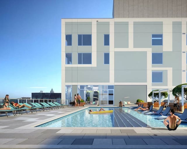 Rooftop pool with lounge chairs and people exterior at The Connector in Atlanta Student Accommodation