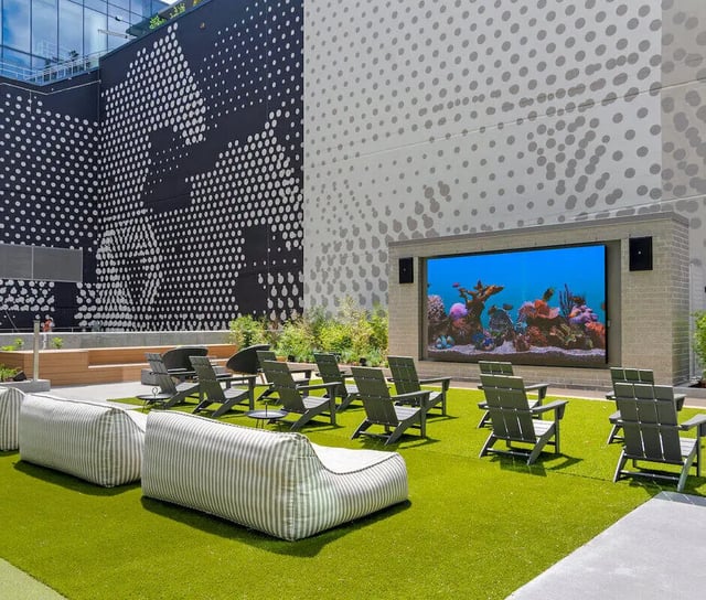 Outdoor lounge chairs and movie screen living area at The Connector in Atlanta Student Accommodation