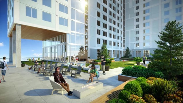 People relaxing on patio near grassy courtyard exterior at The Connector in Atlanta Student Accommodation