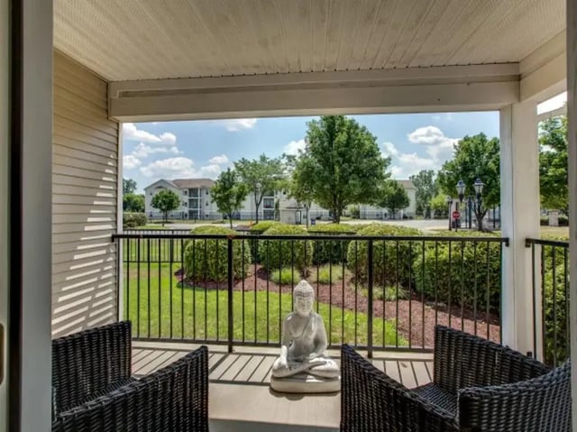 Buddha statue chairs balcony and exterior view at The Landings at Chandler Crossings in East Lansing Student Accommodation